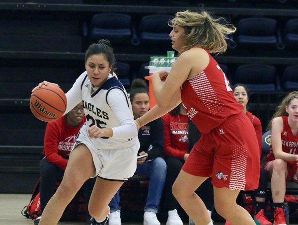 West Hills Golden Eagles' Alondra Ponce drives past Bakersfield's Brianna Mendez in the Lady Eagles win Thursday night in the Golden Eagle Arena.